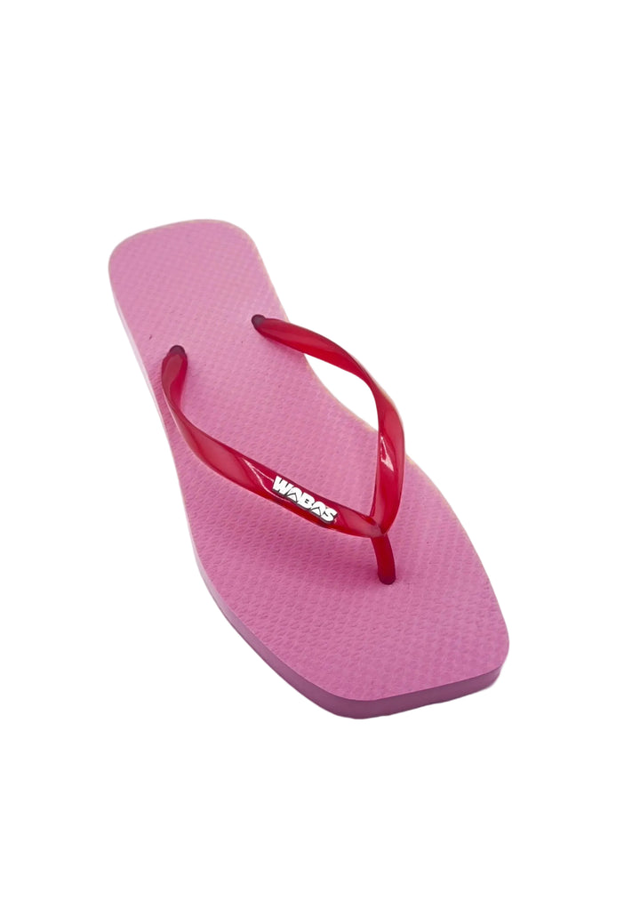 Pink flip-flop with red strap on a white background