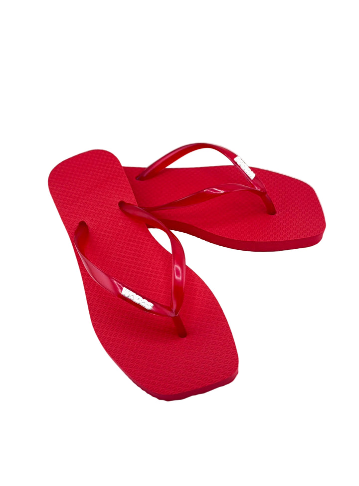Red flip-flops on a white background